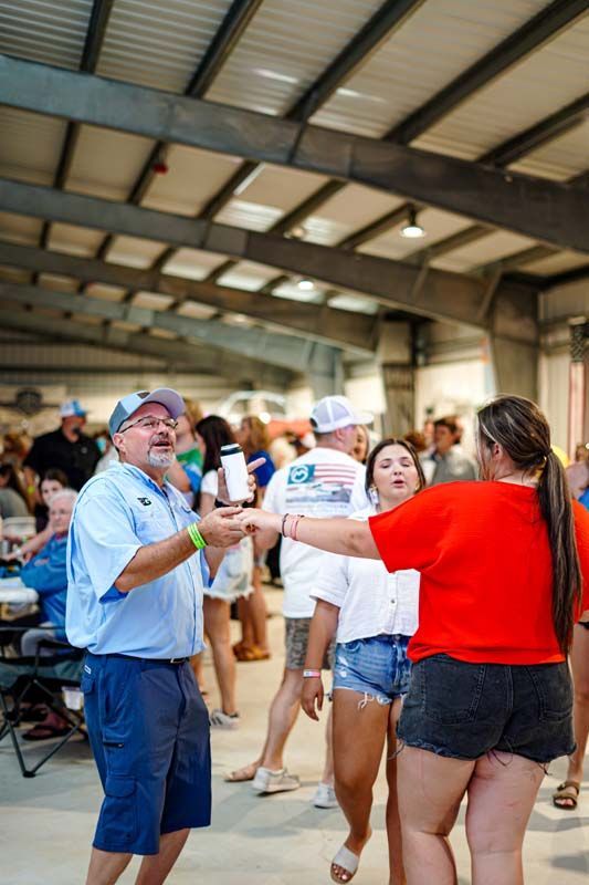 A group of people are dancing in a large room.