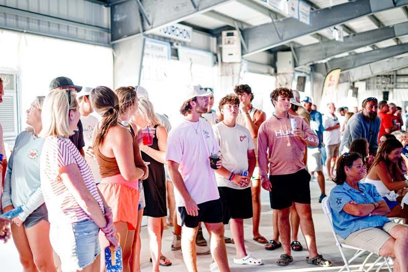 A large group of people are standing in a room.