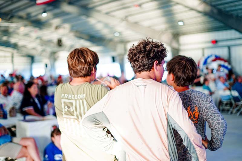 A group of young men are standing next to each other in a room.