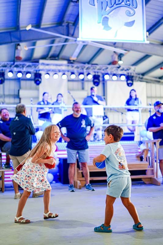 A boy and a girl are standing next to each other on a stage.