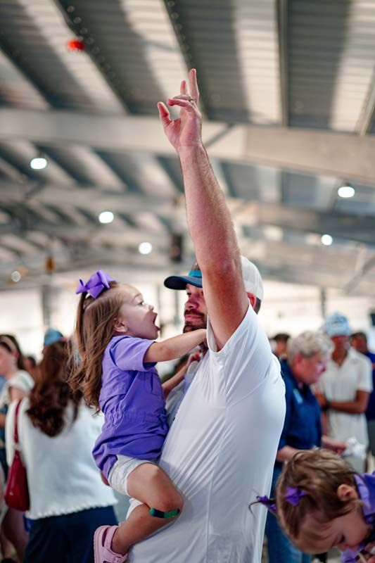 A man is holding a little girl in his arms.