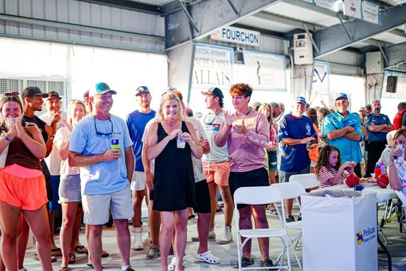 A large group of people are standing in a room.
