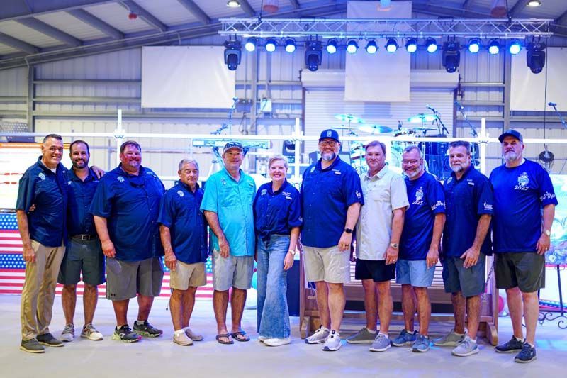 A group of people are posing for a picture in a building.