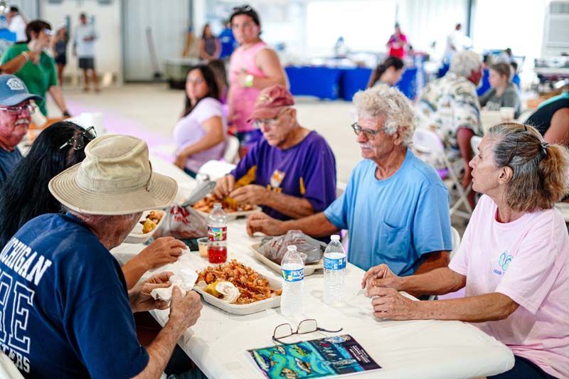 A group of people are sitting at a table eating food.
