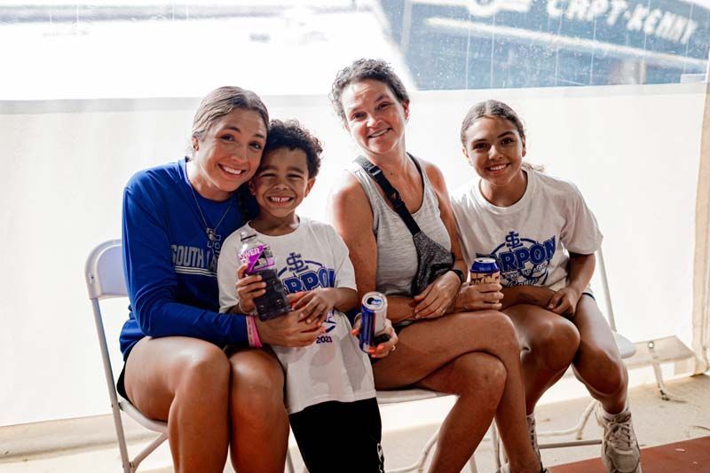 A group of people are sitting on a bench.