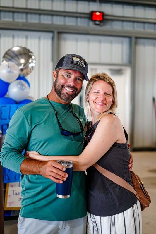 A man and a woman are posing for a picture in a building.