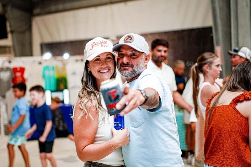 A man and a woman are posing for a picture at a party.