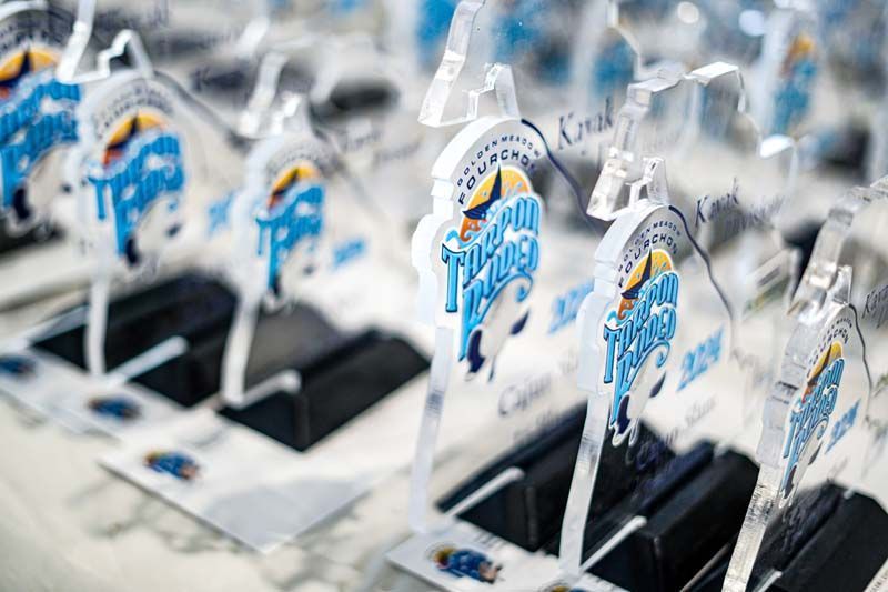 A row of trophies sitting on top of a table.