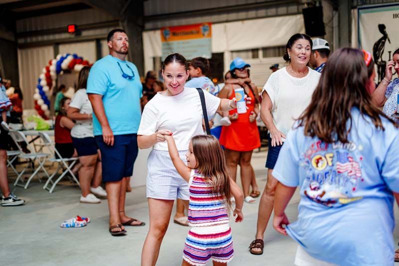 A group of people are dancing together at a party.