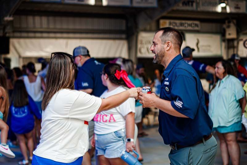 A man and a woman are dancing in a crowd of people.