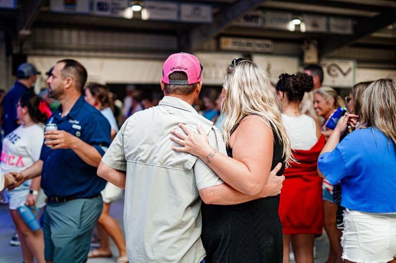 A group of people are dancing together at a party.