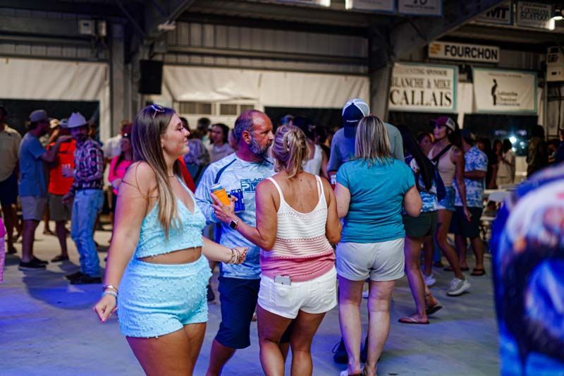 A group of people are dancing in a room at a party.
