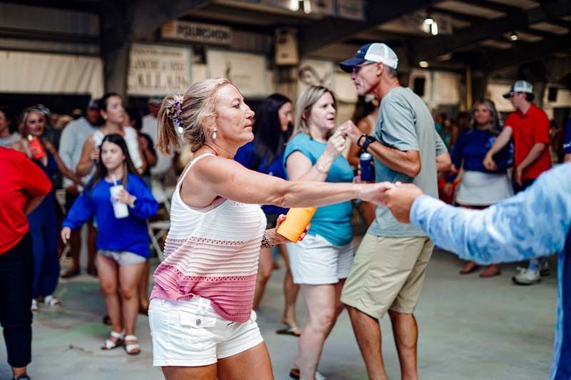 A group of people are dancing together in a room.