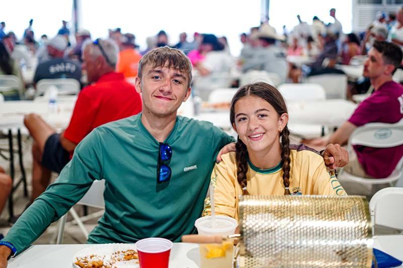 A man and a girl are sitting at a table in a restaurant.
