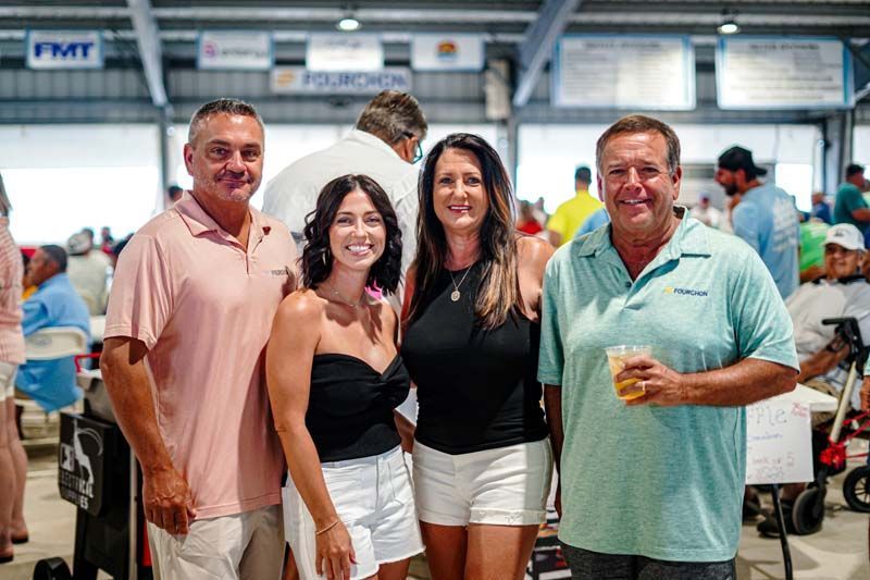 A group of people are posing for a picture at a party.