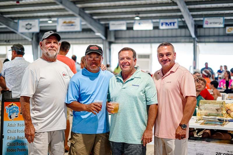A group of men are posing for a picture in a building.