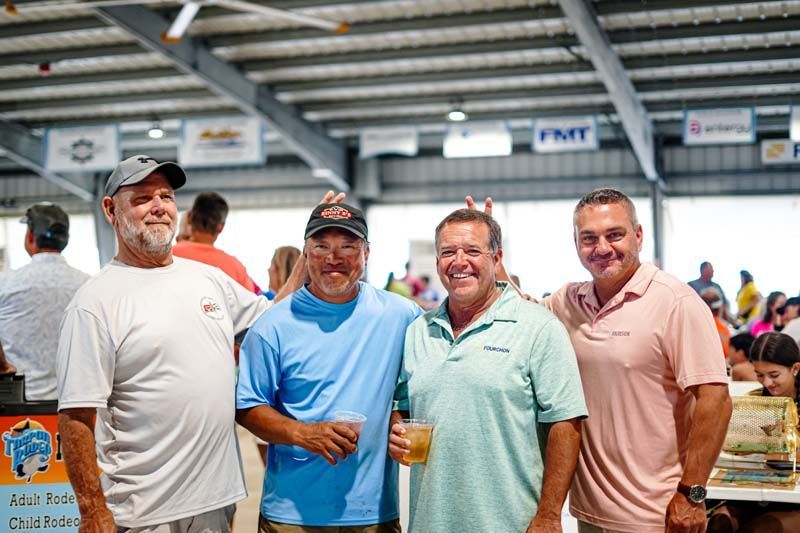 A group of men are posing for a picture in a building.