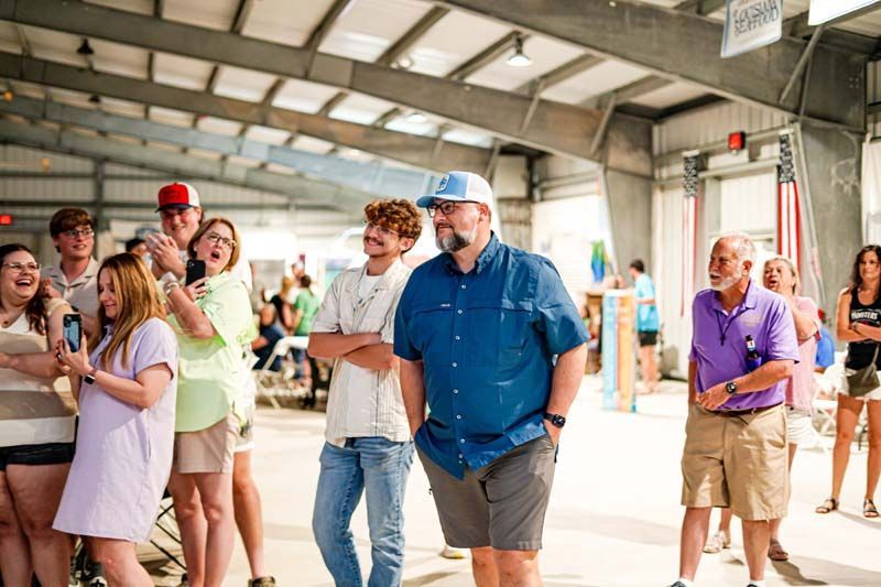 A group of people are standing in a building.