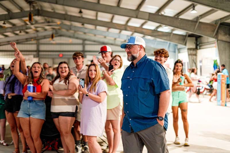 A man is standing in front of a group of people.