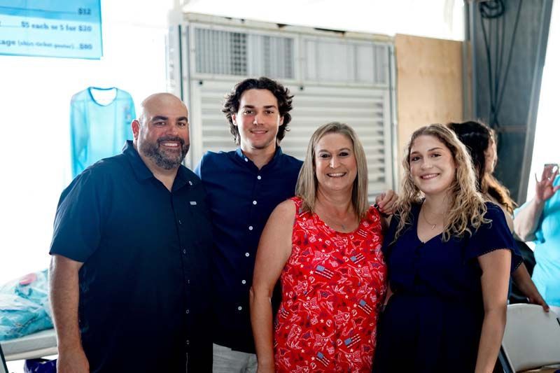 A group of people are posing for a picture together in a room.