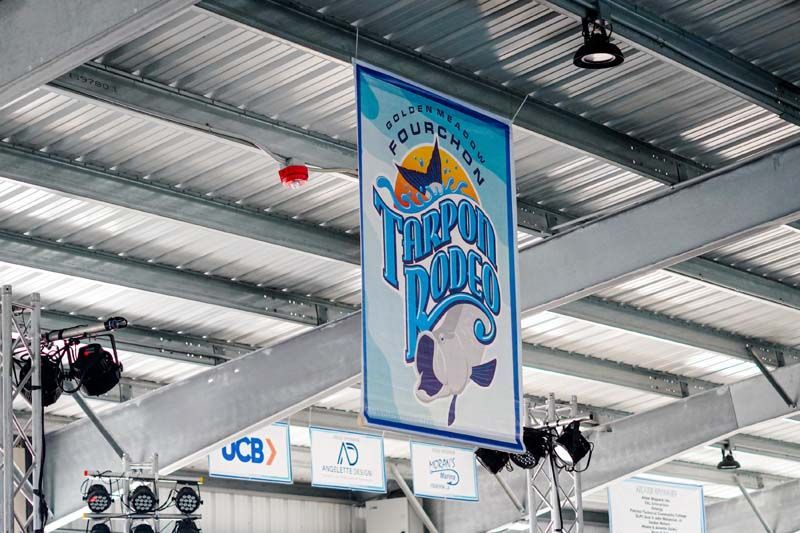 A banner is hanging from the ceiling of a building.