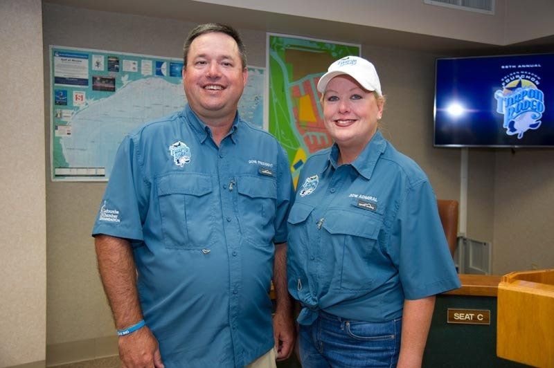 A man and a woman are standing next to each other in a room.