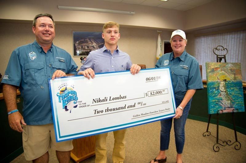 A man and two women are holding a large check.