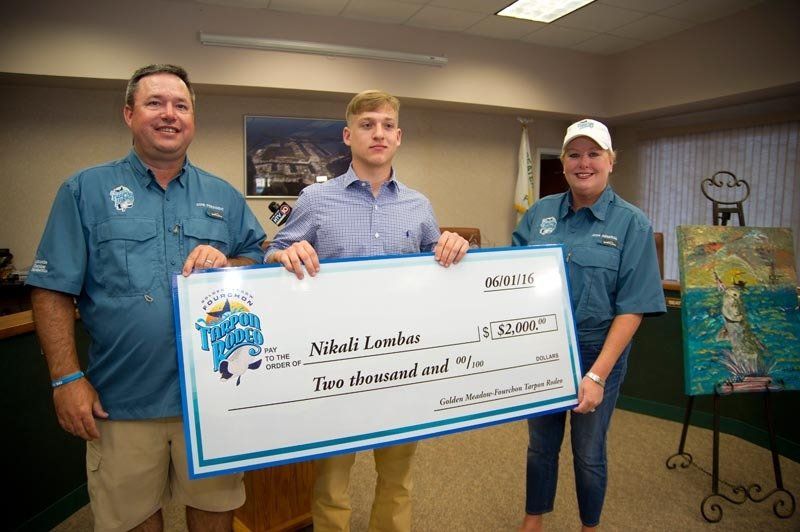 A man and two women are holding a large check.