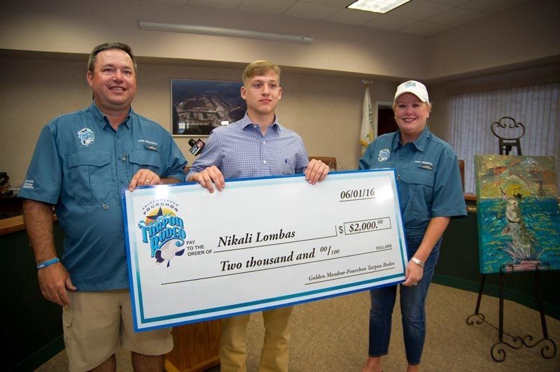 A man and two women are holding a large check.