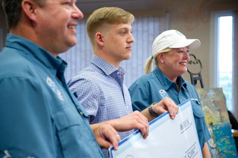 A group of people are standing next to each other holding signs.