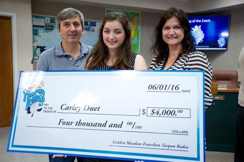 A family holding a four thousand dollar check