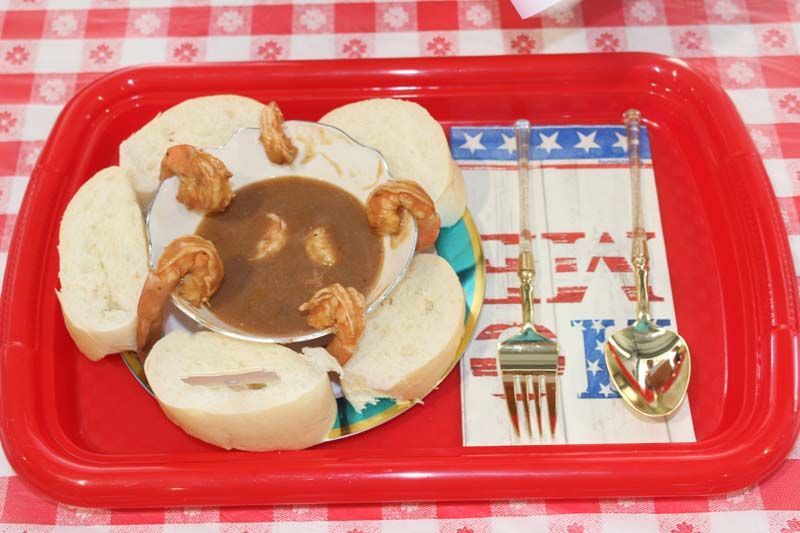 A tray of food with a napkin that says eat on it