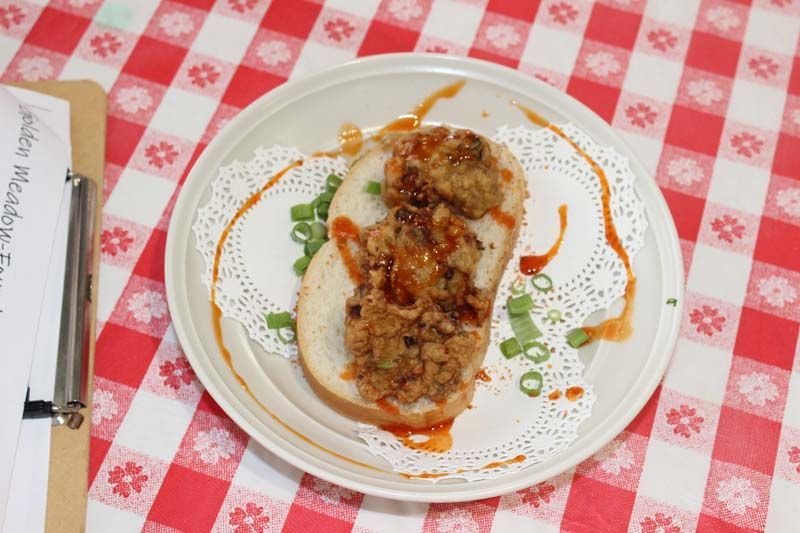 A plate of food is on a checkered table cloth.