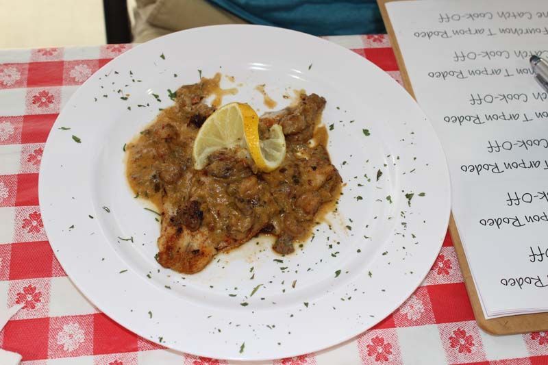 A plate of food with a slice of lemon on top
