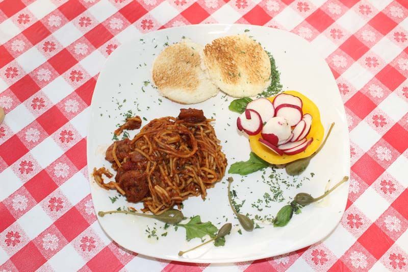 A plate of food on a checkered table cloth