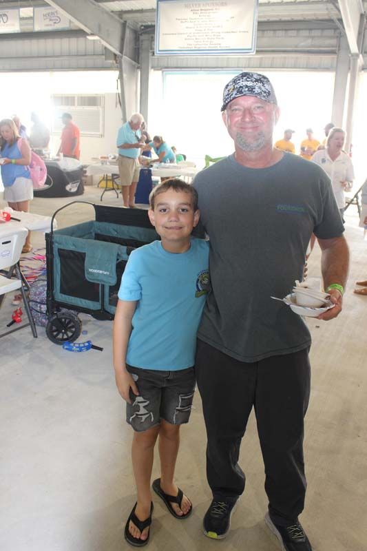 A man and a boy are posing for a picture.