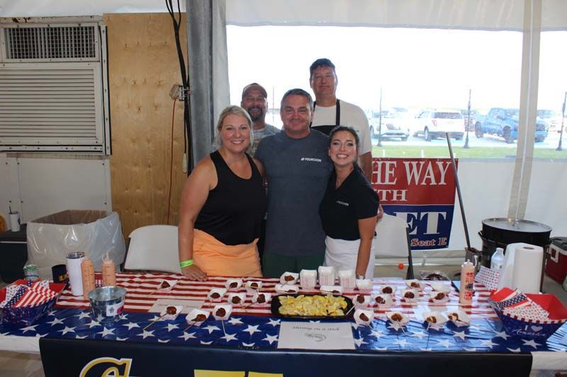 A group of people standing around a table with a sign that says the way