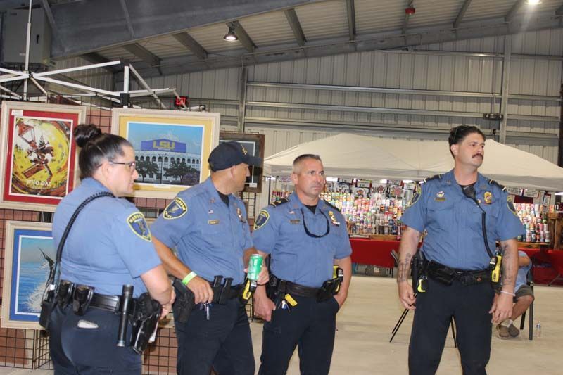 A group of police officers are standing next to each other in a building.