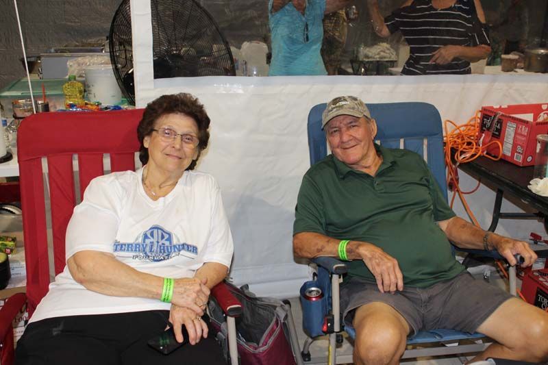 A man and a woman are sitting in chairs in a room.