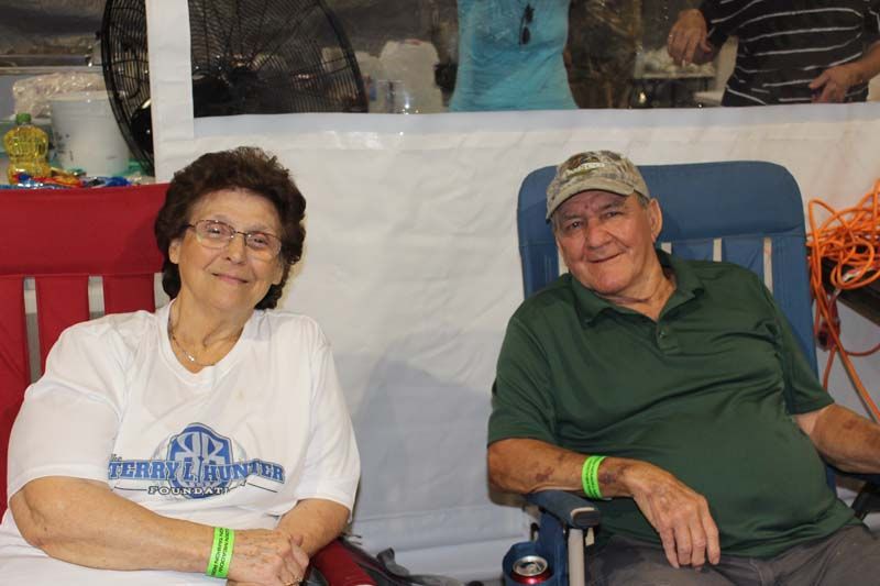 A man and a woman are sitting next to each other in chairs.