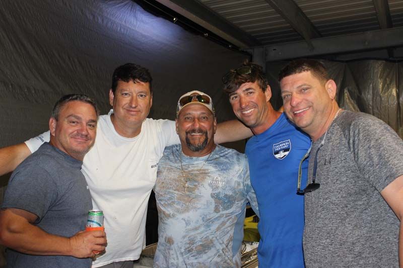 A group of men are posing for a picture together.