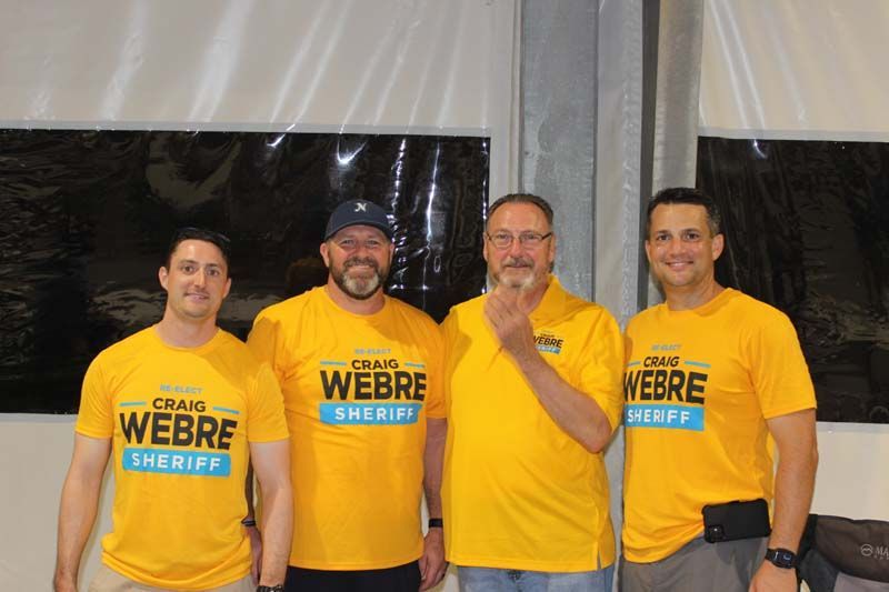 A group of men wearing yellow shirts that say webre sheriff