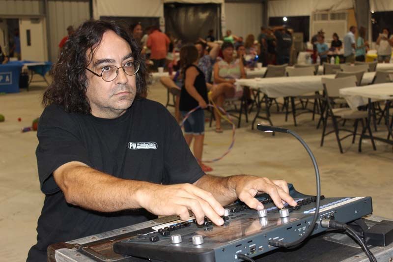 A man in a black shirt is playing a keyboard