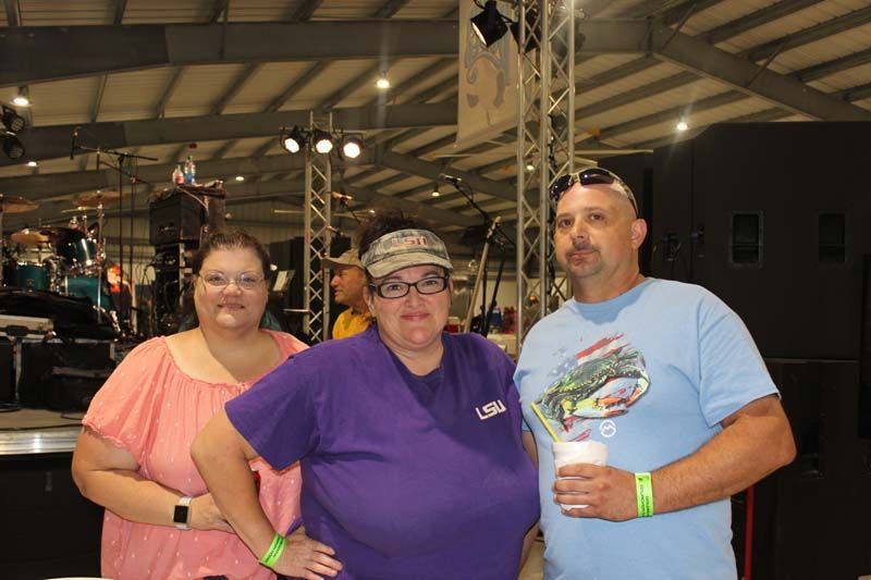 A man and two women are posing for a picture together