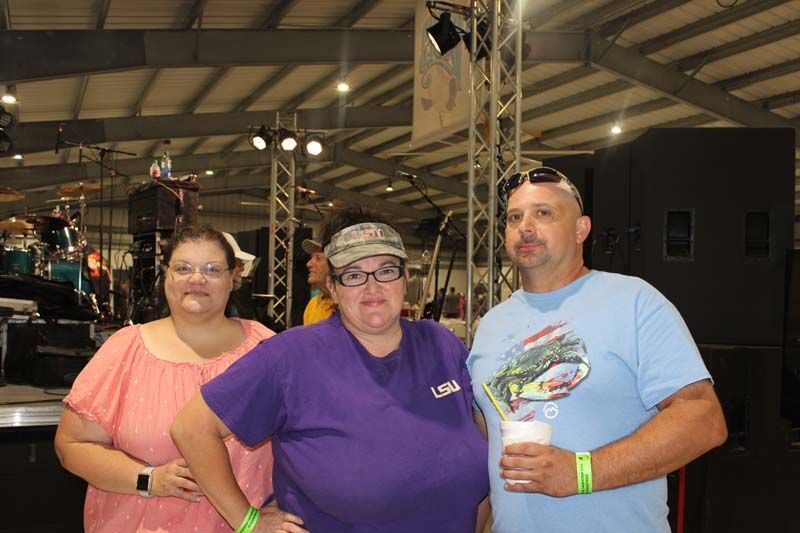 A group of people standing next to each other in a room.