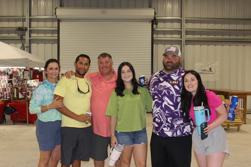 A group of people are posing for a picture in a building.