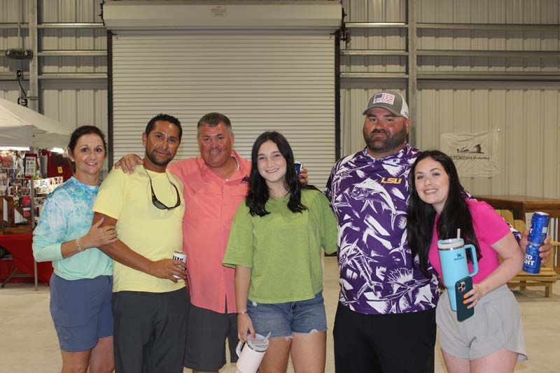A group of people are posing for a picture in a building.