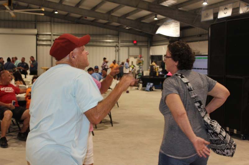 A man in a red hat is talking to a woman