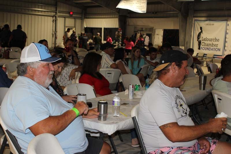 A group of people are sitting at tables in a room.