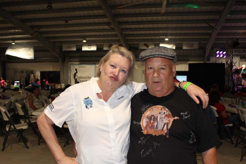 A man and a woman are posing for a picture in a room.